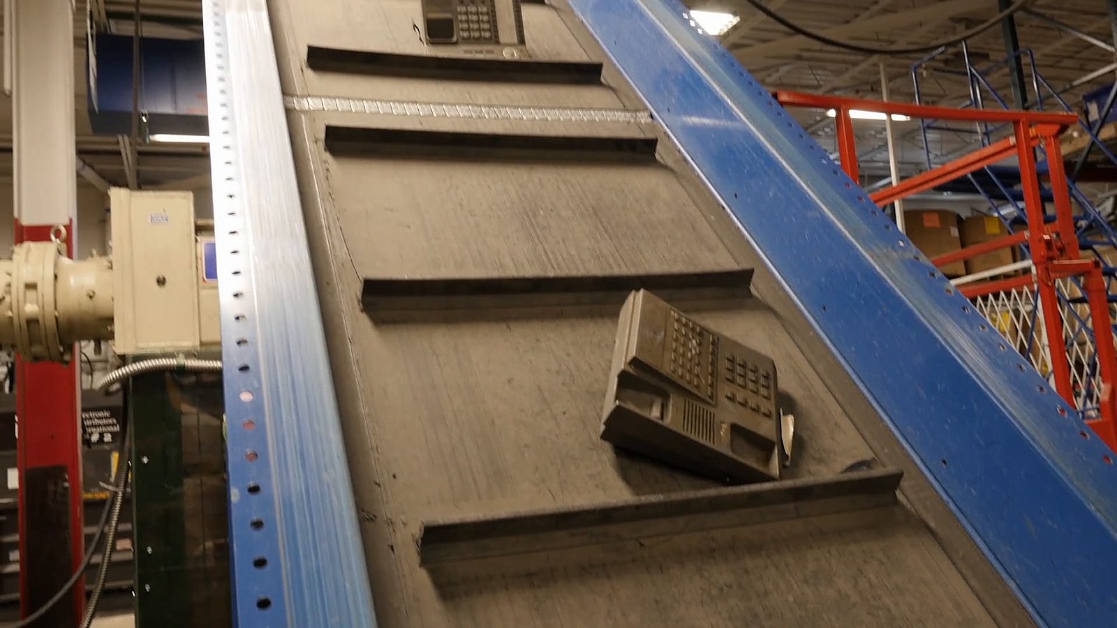 An old desk phone on a conveyor