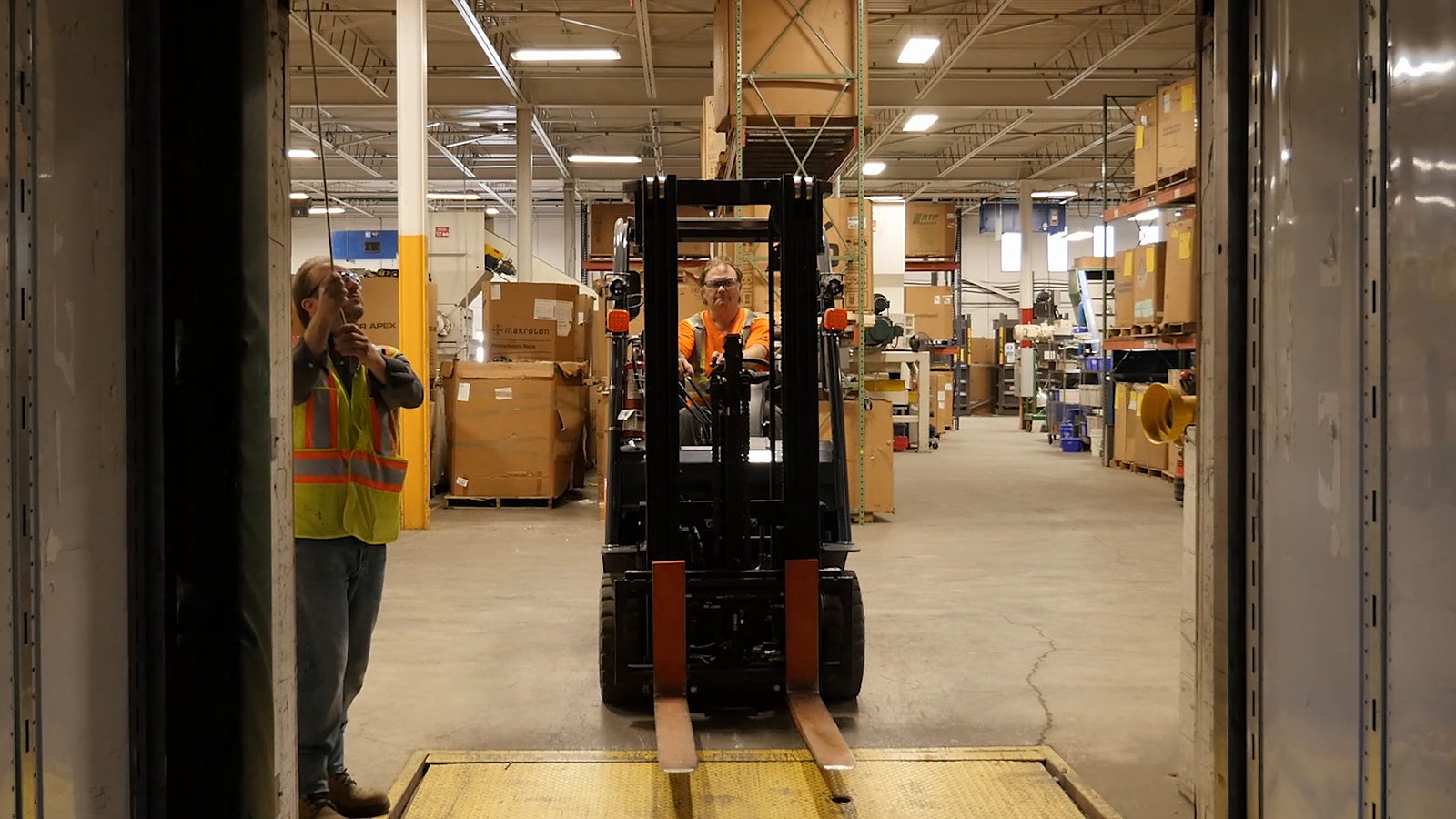 A lift truck coming through a dock door