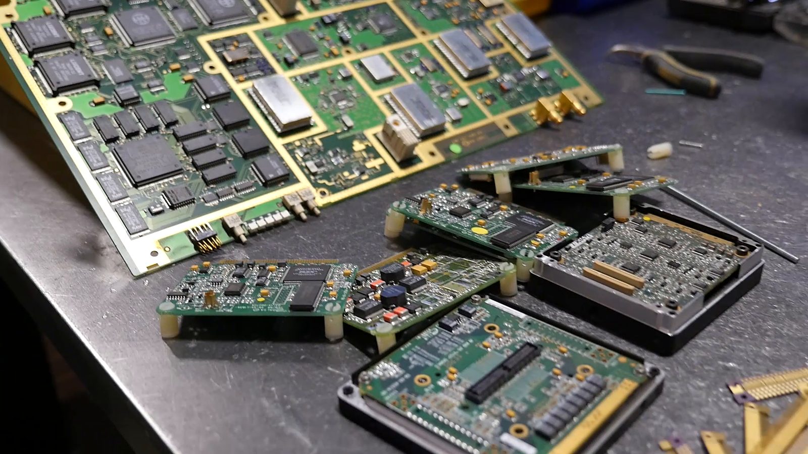 Circuit boards with gold-plated contacts laid out on a workbench