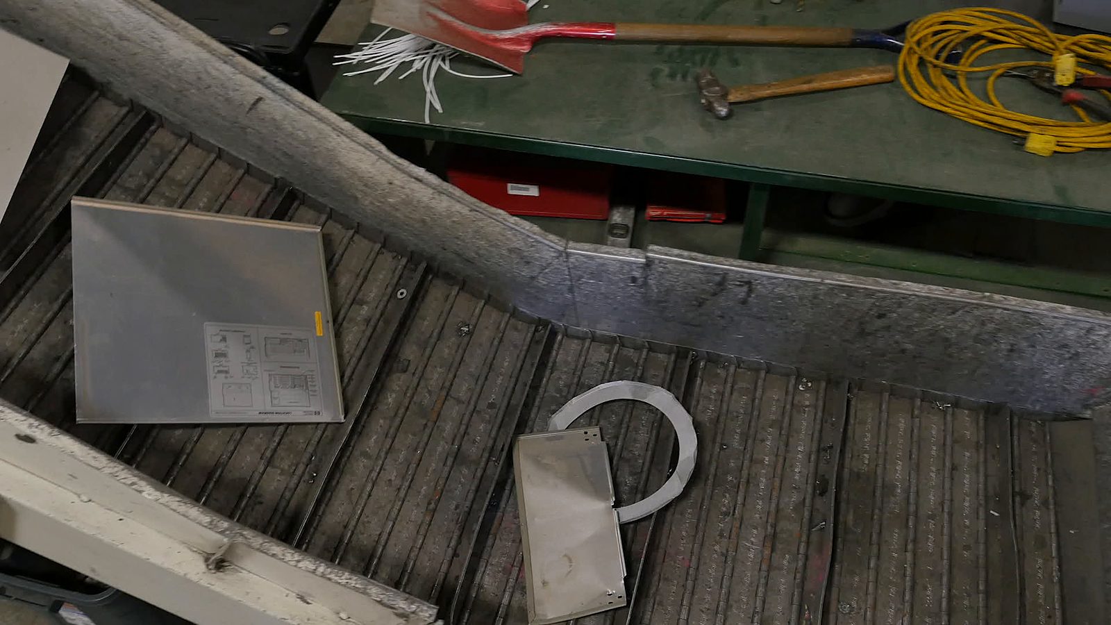 Metal plates and parts on a conveyor