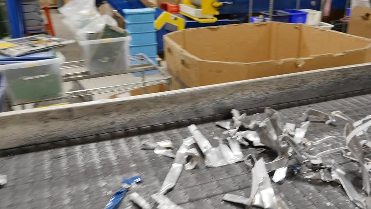 Shredded metal pieces on a conveyor