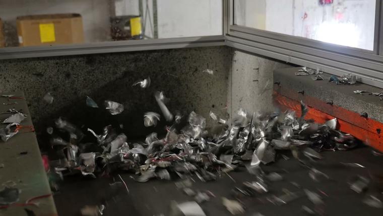 Shredded metal falling off the end of a conveyor